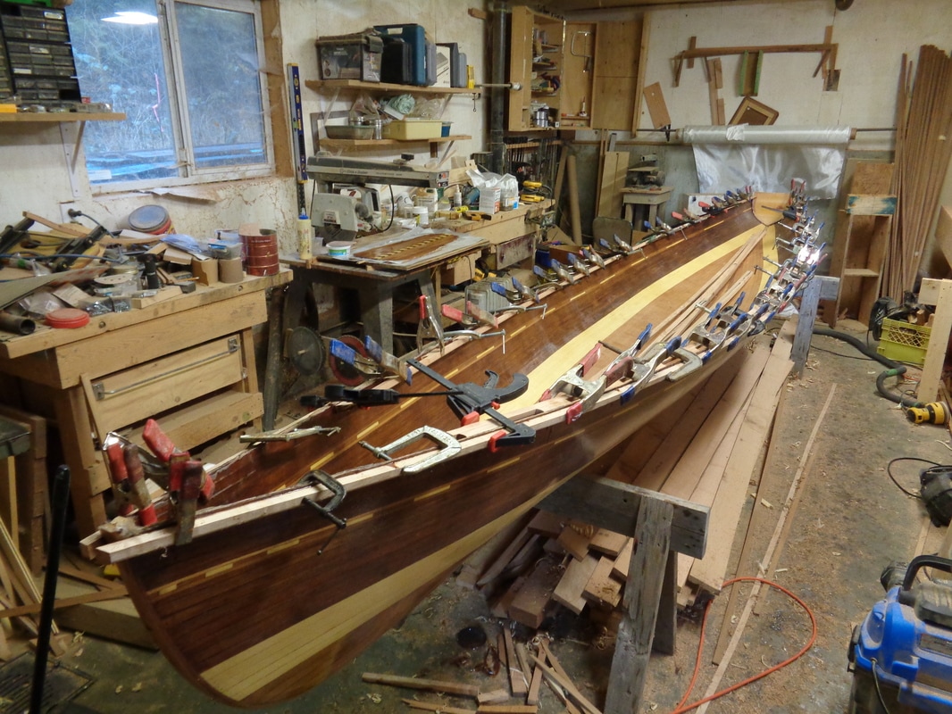 sliding seat rowboat in cedar strip  maple gunwales